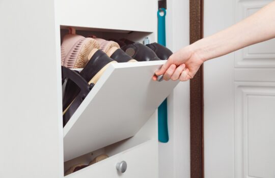 woman-opens-shoe-cabinet-with-footwear-in-hallway-2025-02-13-07-06-07-utc