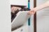 woman-opens-shoe-cabinet-with-footwear-in-hallway-2025-02-13-07-06-07-utc